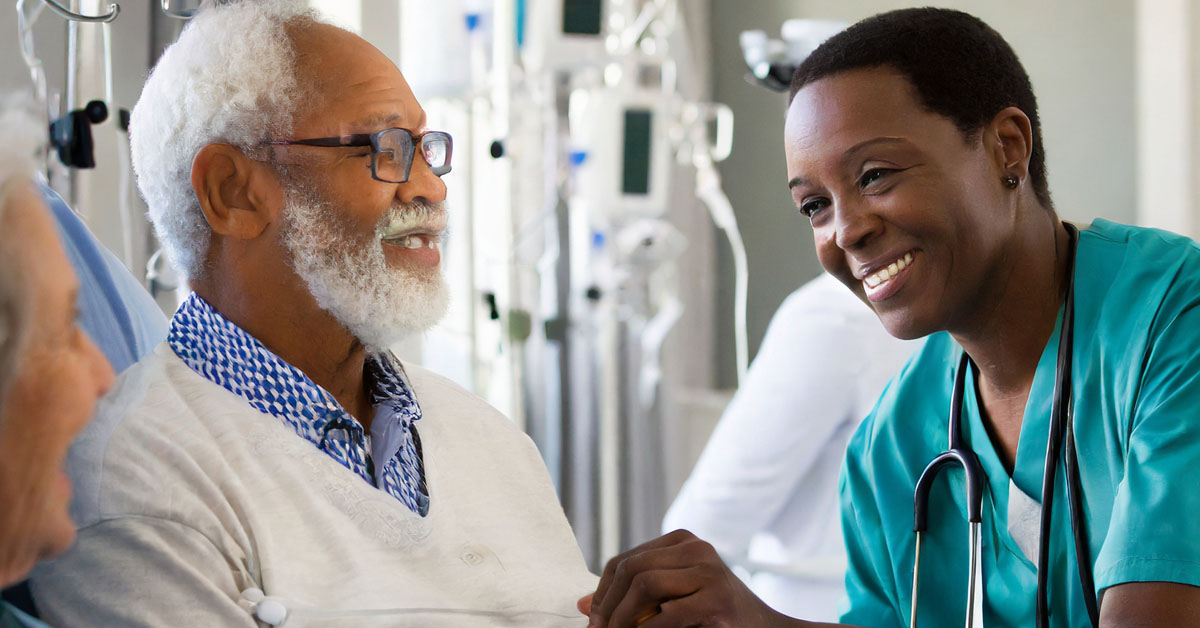 Gentleman speaking to a nurse during hospital discharge session.